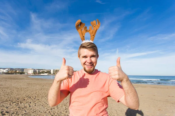 Christmas and holiday concept -Happy man in Christmas costume gesture thumbs up