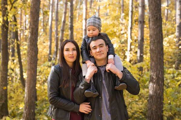 Personer, familj och fritid koncept - mamma, Pappa och lilla dotter ha kul i höst park — Stockfoto