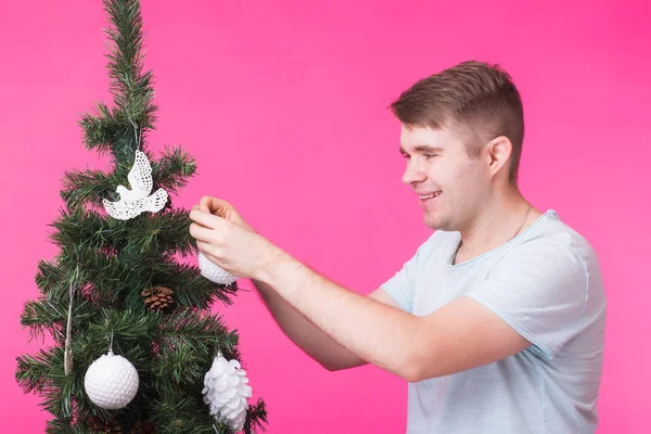 Noel ve tatil kavramı - Noel ağacı adamla pembe bir arka plan üzerinde gülümseyen portresi — Stok fotoğraf