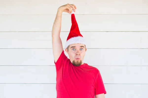 Vacaciones, Navidad y concepto de ropa - sorprendido hombre divertido en traje de santa posando sobre fondo blanco — Foto de Stock