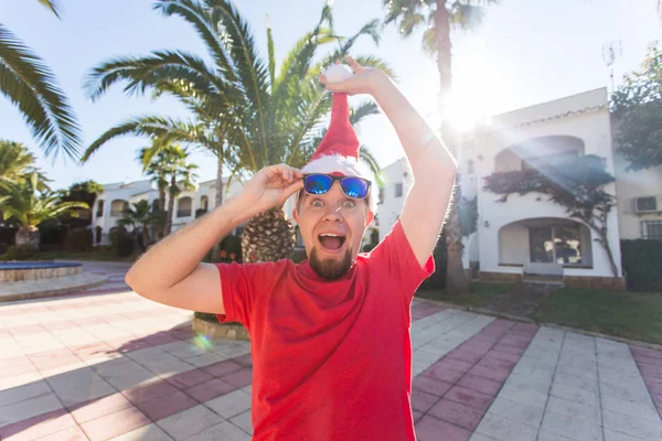 Noel, özel günler, mizah, insanlar kavramı - adam kafasını dan Noel şapka çıkarmak