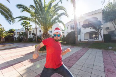 Santa Claus şapka içinde açık dans genç adam.