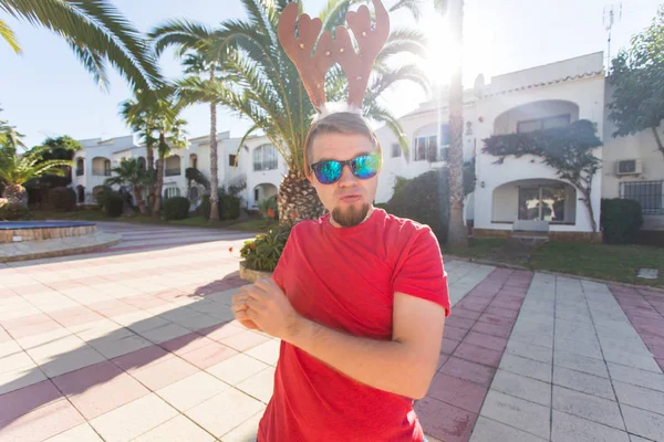 Tatil ve insanlar kavramı - Noel geyik boynuzları açık havada dans komik adam