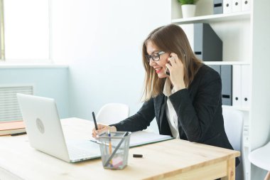 İşletme, Emlak ve insanlar kavramı - ofis telefon ve yapmak notlar üzerinde konuşmak çekici kadın
