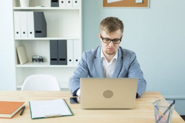 İş, teknolojileri ve insan kavramı - laptop ofiste çalışan yakışıklı adam