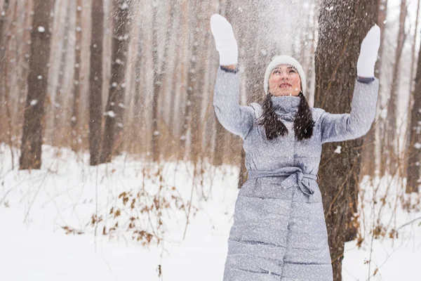 Jovem mulher bonita jogando neve no ar em férias de inverno — Fotografia de Stock