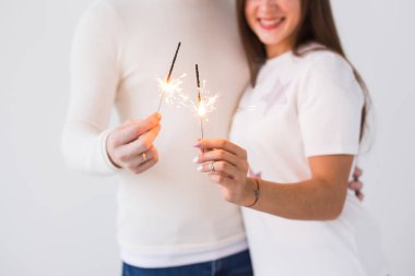 Romantik güzel çift tarihi Valentines gün olması. Erkek ve kadın şampanya bardağı ve maytap tutarak yakından.