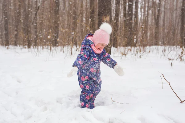 Children, winter and nature concept - Close up of adorable kid playing with snow in the park — Stock Photo, Image