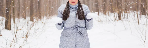 Season, leisure and people concept - close up of woman is happy and throwing snow in the winter nature — Stock Photo, Image
