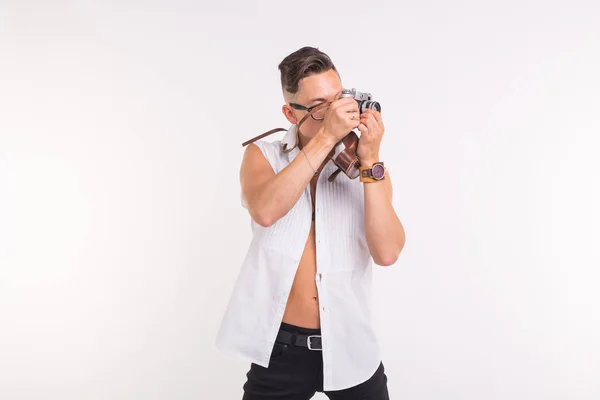 Технологии, фотографирование и концепция людей - красивый молодой человек с ретро камерой на белом фоне — стоковое фото