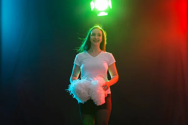 Retrato de una joven animadora bailando con pompones — Foto de Stock