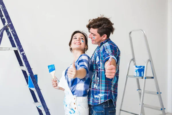 Repair, renovation and people concept - Woman and man gestured thumbs up — Stock Photo, Image