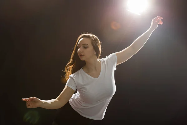 People and dancing concept - Young beautiful sporty woman dancing jazz funk on a black studio background — Stock Photo, Image