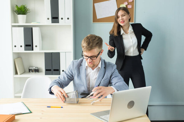 Business, emotions and people concept - Disgruntled boss watch as the employee works.