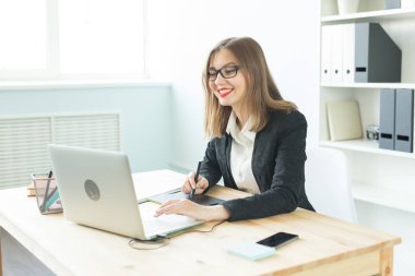 Çalışma, iş, teknoloji ve tasarımcı kavramı - tablet kullanarak ve dizüstü izlerken genç kadın