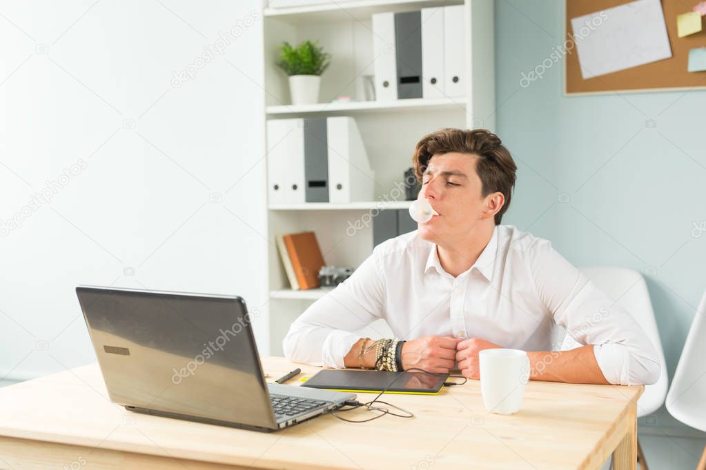 Joke, office, humor, people concept - handsome man chewing gum and thinking about something, huge bubble