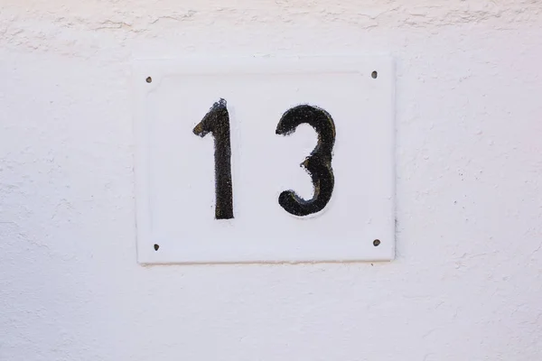 House number Thirteen on Stone Wall close-up — Stock Photo, Image