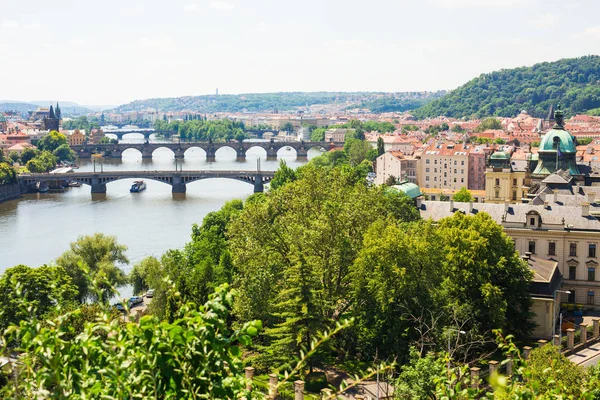 Scenic view of bridges on the Vltava river and of the historical center of Prague: buildings and landmarks of old town with red rooftops — Stock Photo, Image