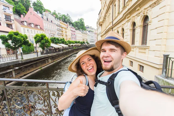 Feliz joven pareja enamorada toma retrato de selfie en Karlovy Vary en República Checa. Los turistas bonitos hacen fotos divertidas para el blog de viajes en Europa — Foto de Stock