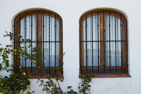 Design, arkitektur och exteriör koncept - två fönster med galler på den vita fasaden — Stockfoto