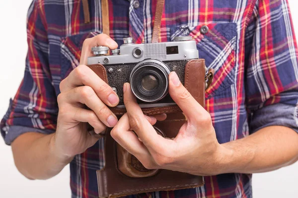 Vintage, photographer and hobby concept - close up of retro camera in mans hands over the white background — Stock Photo, Image