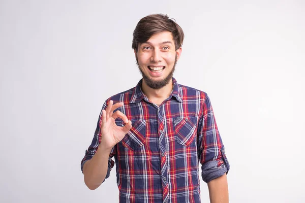 Gestures, signs and people concept - smiling confused man shows okay sign over the white background — Stock Photo, Image