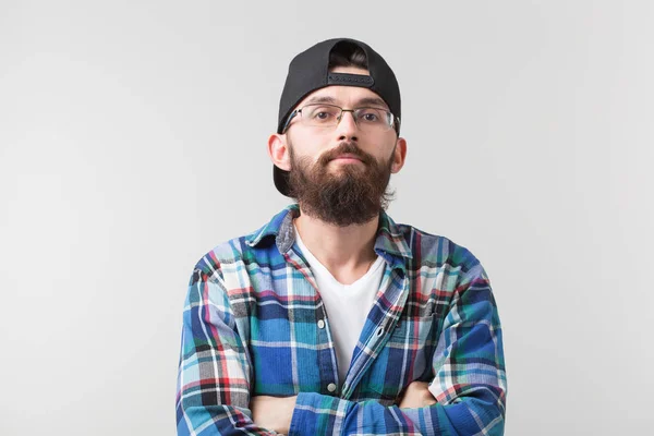 Concepto de belleza, moda y gente - Retrato de un joven barbudo hipster con estilo sobre fondo blanco . — Foto de Stock