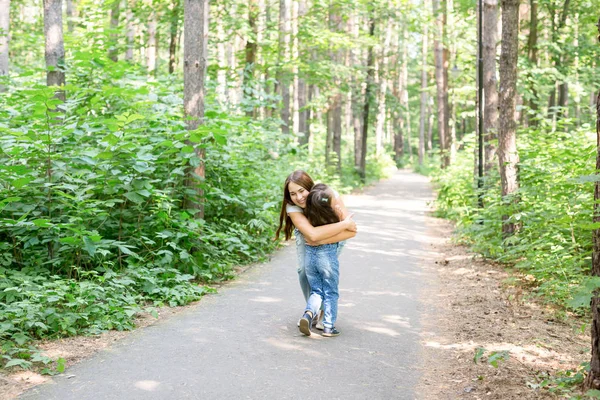 Elternschaft, Natur und Kinder-Konzept - Mutter und Tochter kuscheln im Sommerpark — Stockfoto