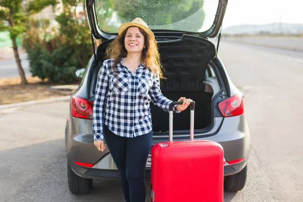 Lidé, doprava a cestování koncepce - veselá žena je stojící poblíž její auto a zavírání kufru. — Stock fotografie