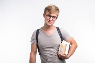 Reading, education, people concept - a young student man holding many books clipart