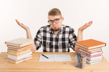 İnsanlar ve eğitim kavramı - kitap ve defterini ile tahta masada oturan karışık öğrenci adam