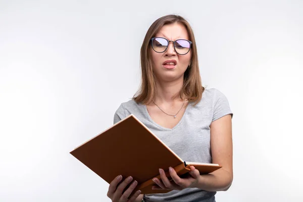 Estudo, educação, conceito de pessoas - estudante está cansado de aprender aulas, ela está de camisa cinza, de pé com livro aberto — Fotografia de Stock