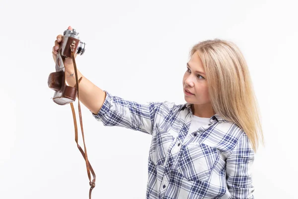Mensen, fotograaf en gebaar concept - vrouw met behulp van een ouderwetse camera kijken door de lens op witte achtergrond — Stockfoto