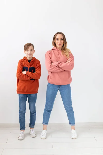 Muttertag, Kinder und Familienkonzept - Teenager-Junge und seine Mutter posieren auf weißem Hintergrund — Stockfoto