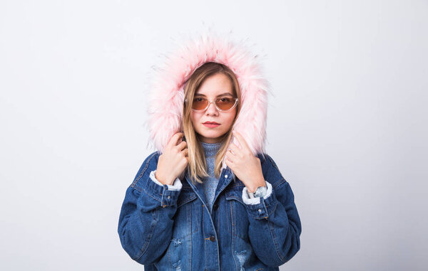 People, urban style and fashion concept - Stylish hipster girl wearing jeans coat on white background