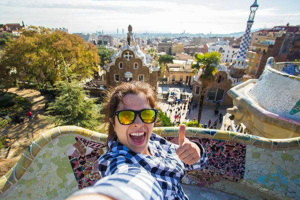 Reise- und Urlaubskonzept - schöne junge Frau beim Fotografieren mit Smartphone in Park Güell, Barcelona, Spanien. — Stockfoto