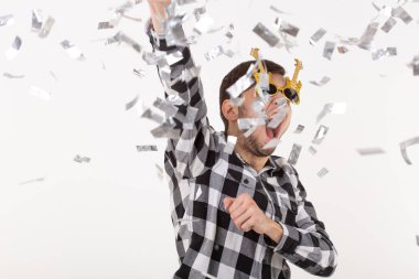 İnsanlar, tatil ve parti kavramı - konfeti ile beyaz arka plan üzerinde ekose gömlekli Cool adam