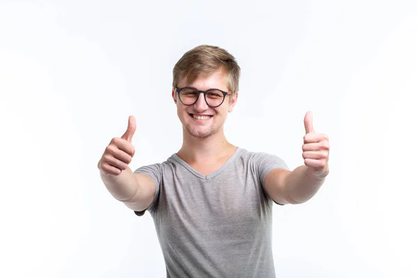 Youth, student and people concept - young man looks like a nerd show us thumbs up over the white background — Stock Photo, Image