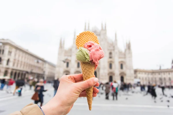 Travel, Italy and holidays concept - Ice cream in front of Milan Cathedral Duomo