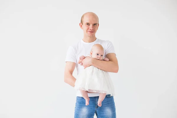 Concepto de familia, paternidad e hijos - padre calvo sosteniendo lindo recién nacido sobre fondo blanco con espacio para copiar — Foto de Stock