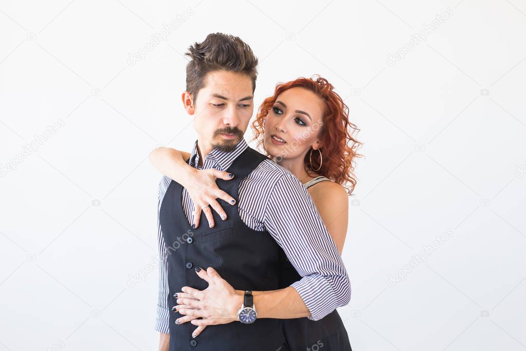 Social dance, bachata, kizomba, people concept - Woman hugs man while dancing over white background
