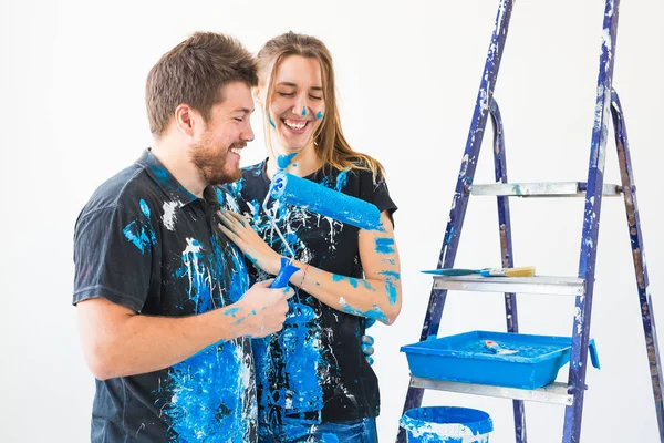 Renovación, reparación y concepto familiar - una pareja joven haciendo una reparación en un nuevo hogar — Foto de Stock