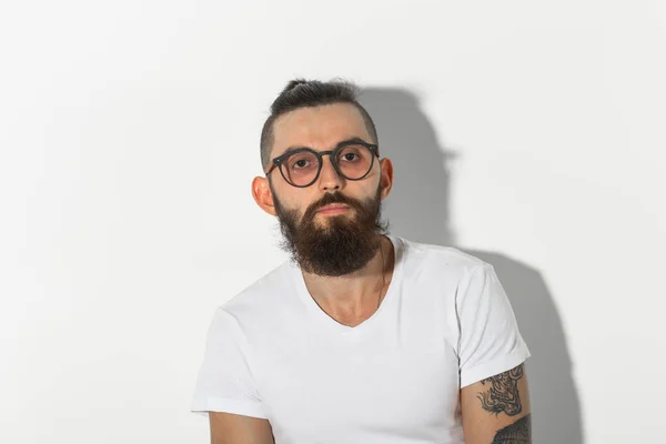 Beauty, fashion and people concept - Hipster man with beard posing over white background — Stock Photo, Image