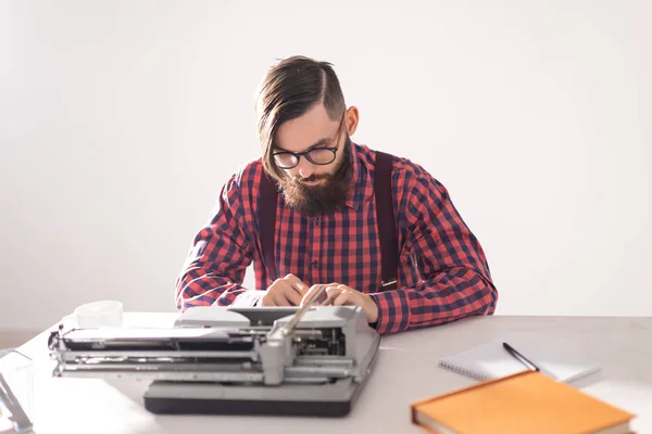 People and technology concept - Portrait of bearded man in plaid shirt typing over grey background