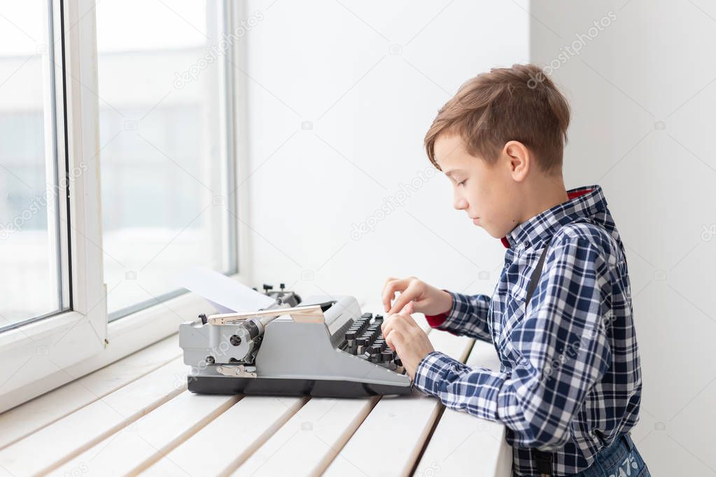 World day of the writer concept - Boy with an old typewriter