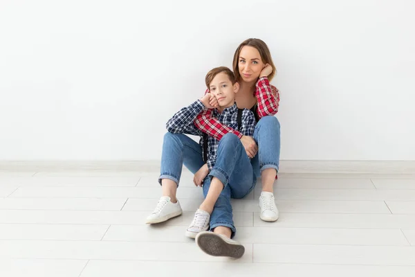 Familia, día de la madre y concepto de adolescente - Retrato de la madre y el hijo sentado en el suelo — Foto de Stock