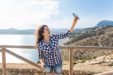 Seyahat, turizm ve tatil kavramı - selfie bir denize yakın alarak mutlu genç kadın