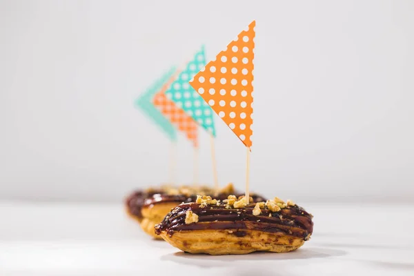 Food, desserts and bakery concept - Eclairs with chocolate decorated as a ship