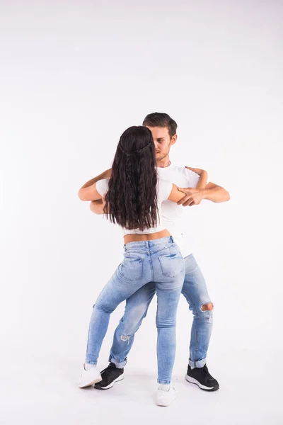年轻夫妇跳舞社交拉丁舞蹈巴查塔, 梅伦格, 萨尔萨。白色背景上的两个优雅的姿势 — 图库照片