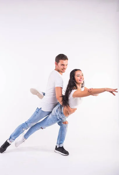 Young couple dancing social latin dance bachata, merengue, salsa. Two elegance pose on white background